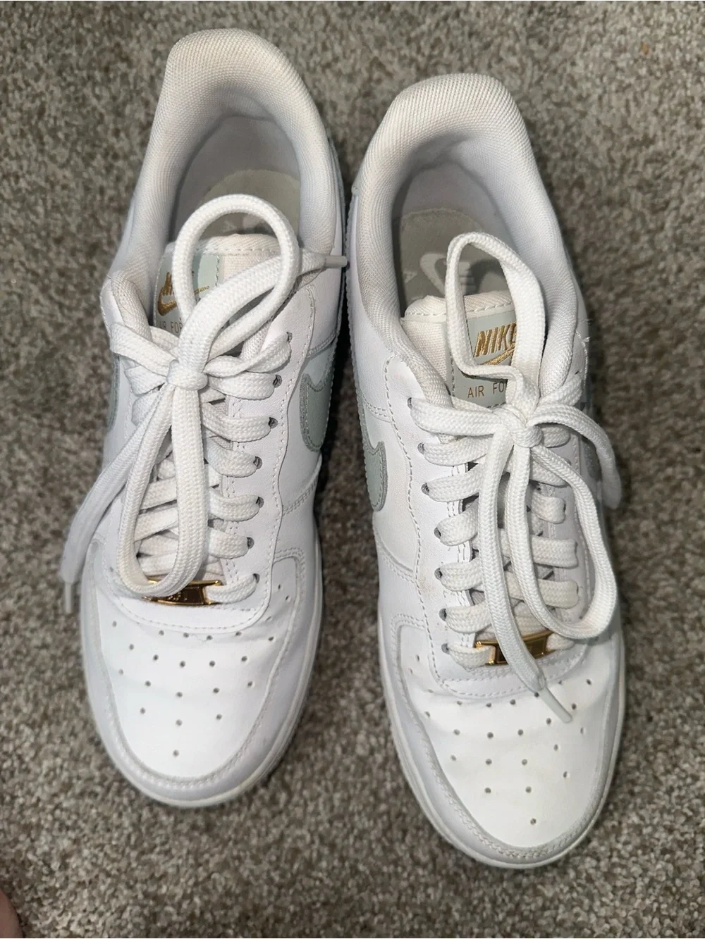 Nike White Sneakers with Sage Green Swoosh and Gold Accent